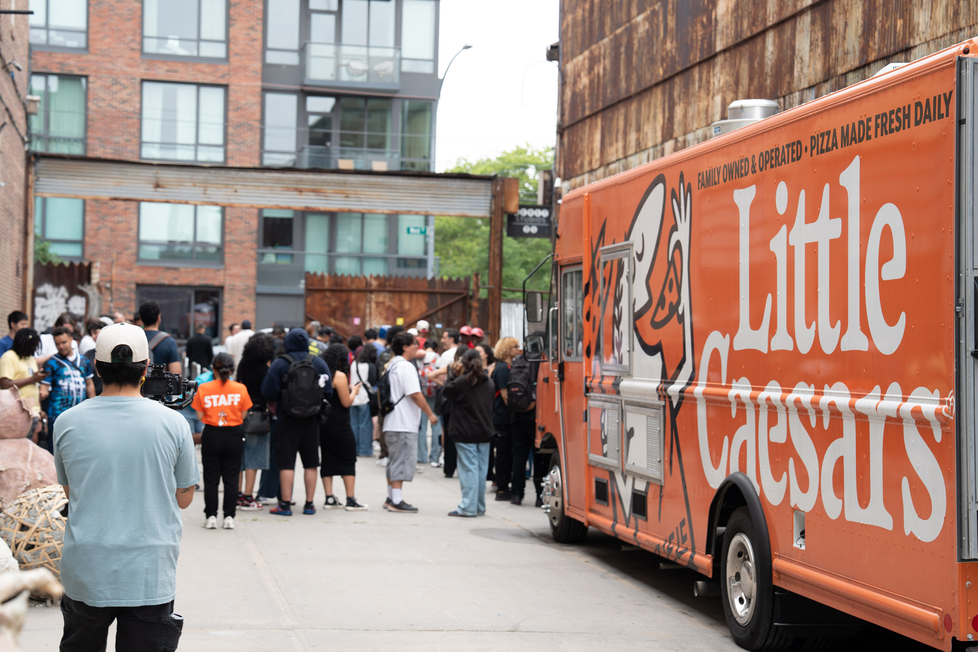 Little Caesars food truck serving the line outside the warehouse
