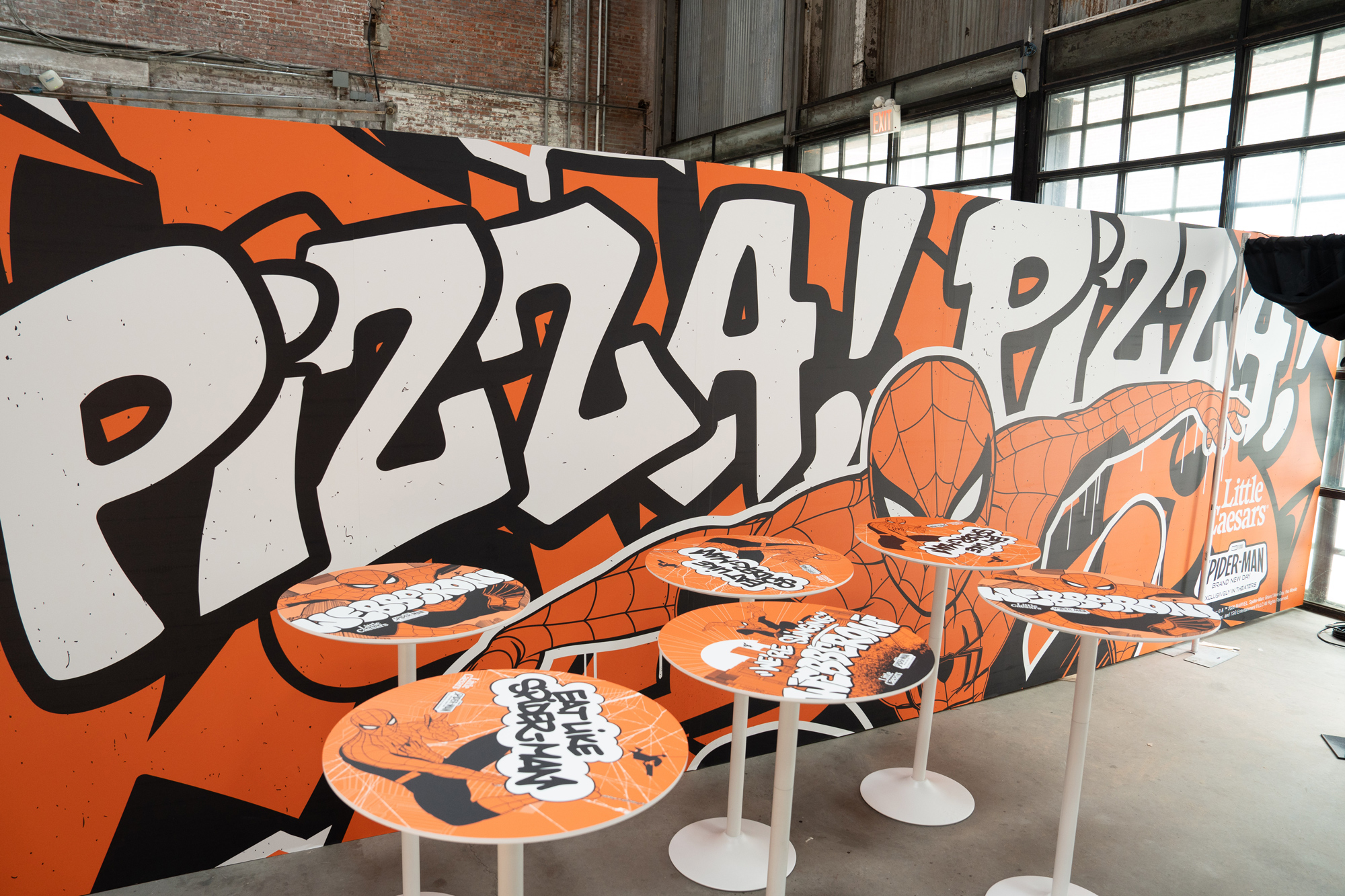 Large-format Webberoni wall graphic with Spider-Man reaching for a slice