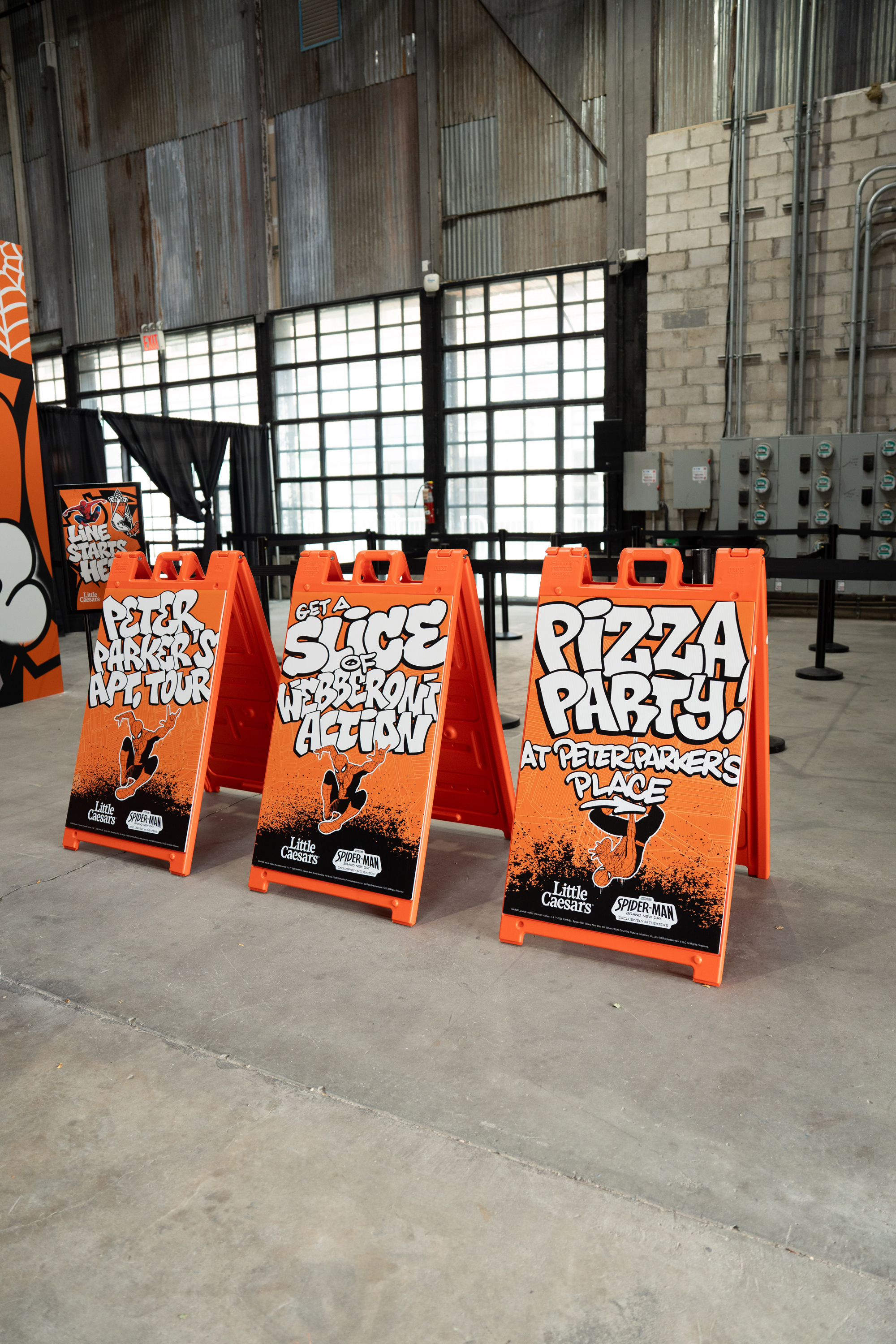 Wayfinding A-frame signs for Peter Parker's Apartment Tour, Webberoni Action, and the Pizza Party