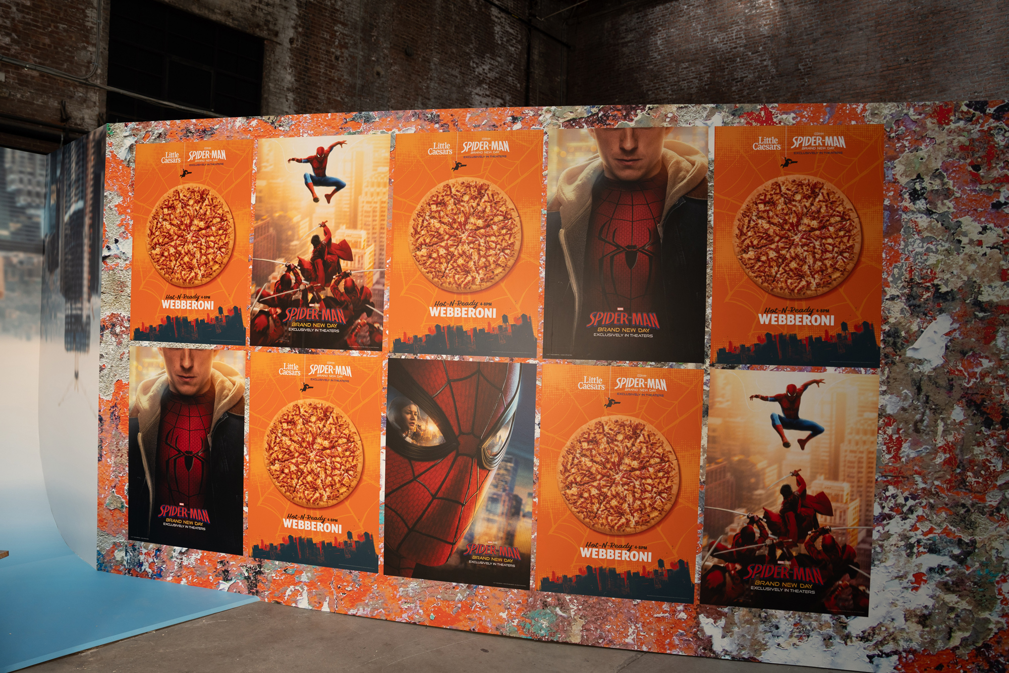 Grid of Webberoni and Spider-Man: Brand New Day one-sheets on a painted wall